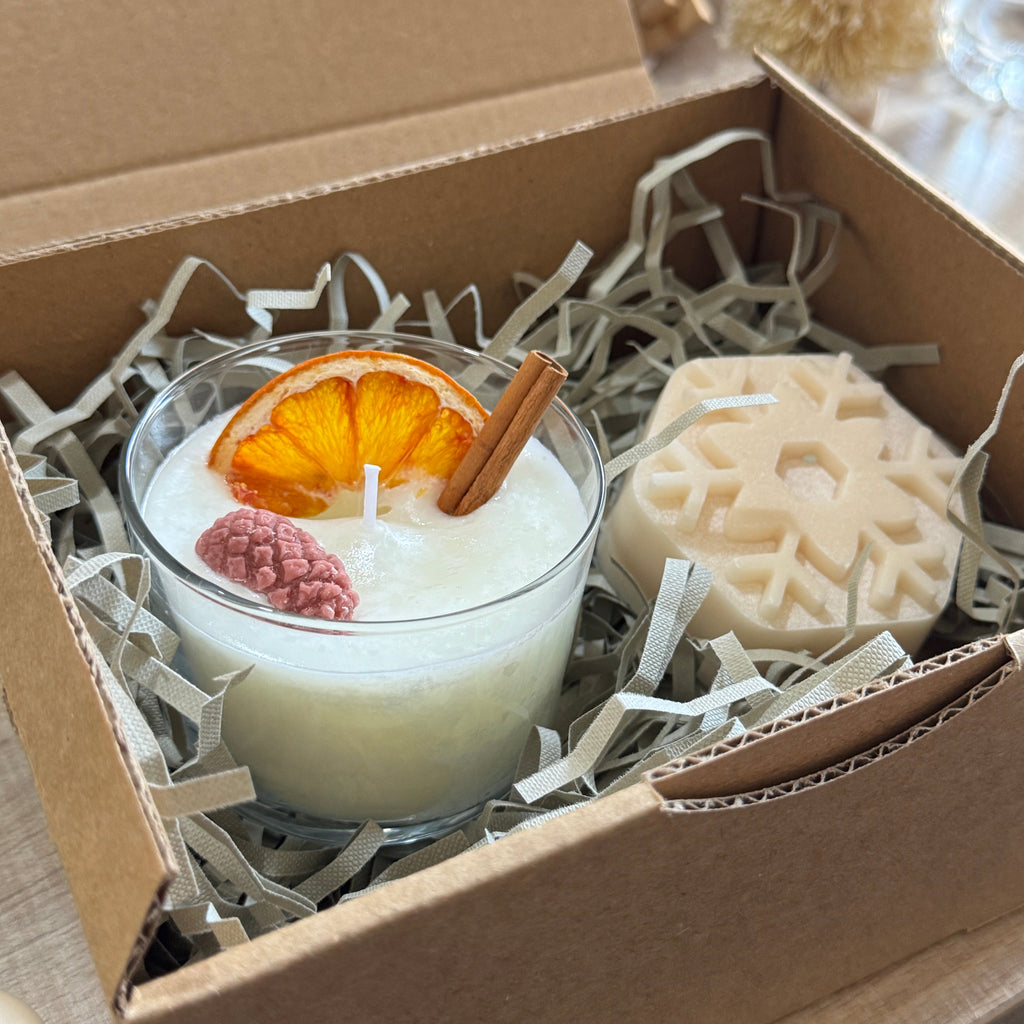 Candle with decorative elements and soap in a cardboard box